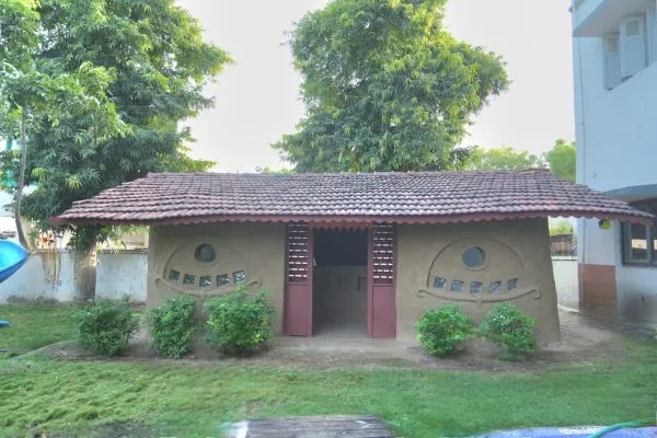 Alpha International School Ahmedabad students creating mud house model – hands-on learning activity